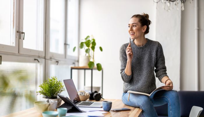 Young female freelancer working in loft office